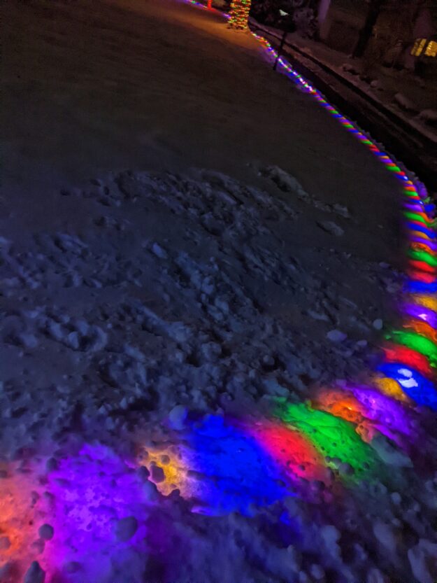 snow covers Christmas lights, making nice glowing bumps